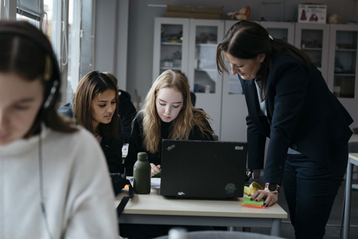 En gruppe personr som ser på en bærbar datamaskin En gruppe personr som ser på en bærbar datamaskin